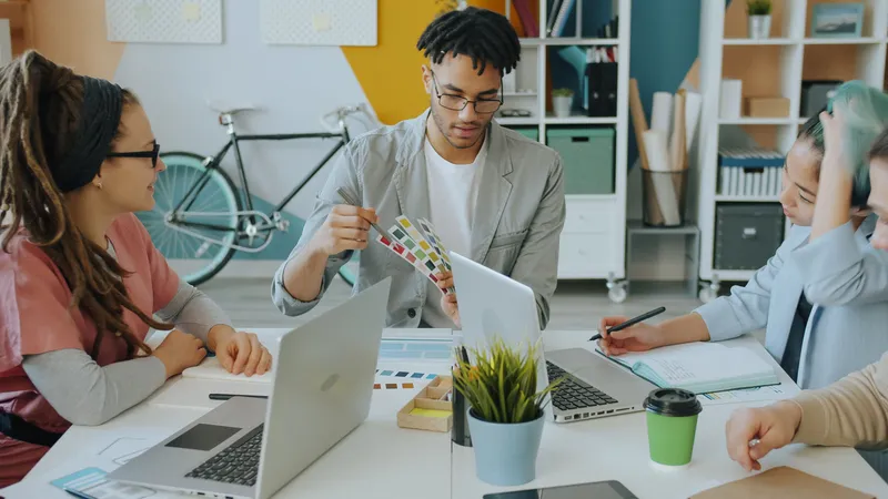 A design team choosing colours together around a bright studio table